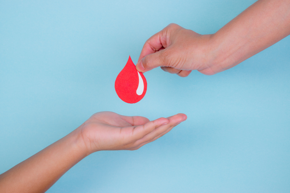 woman-hand-gives-red-blood-drop-boy-hand-blood-donation-concept-world-blood-donor-day